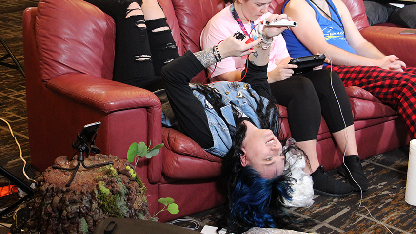 An attendee, playing the game upside-down.